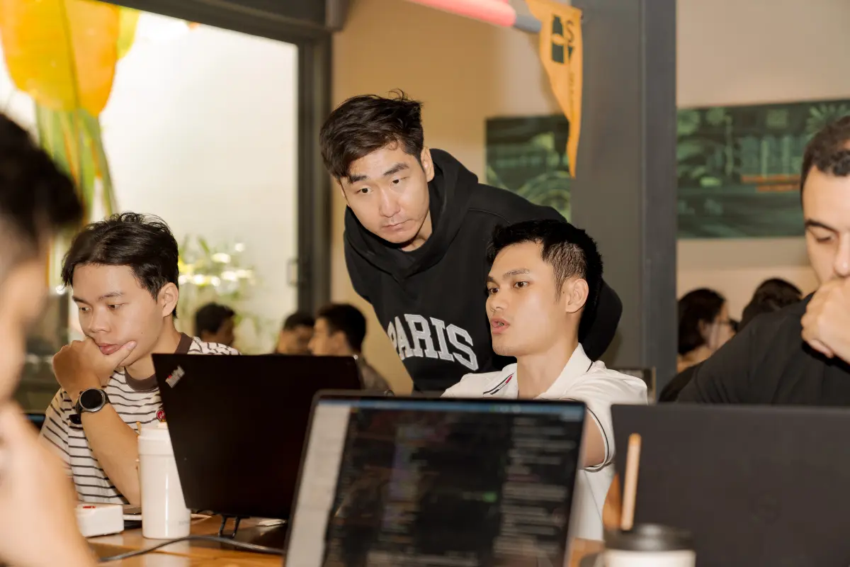 Two builders comparing workflows
